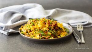 A savoury keto waffle topped with scrambled eggs